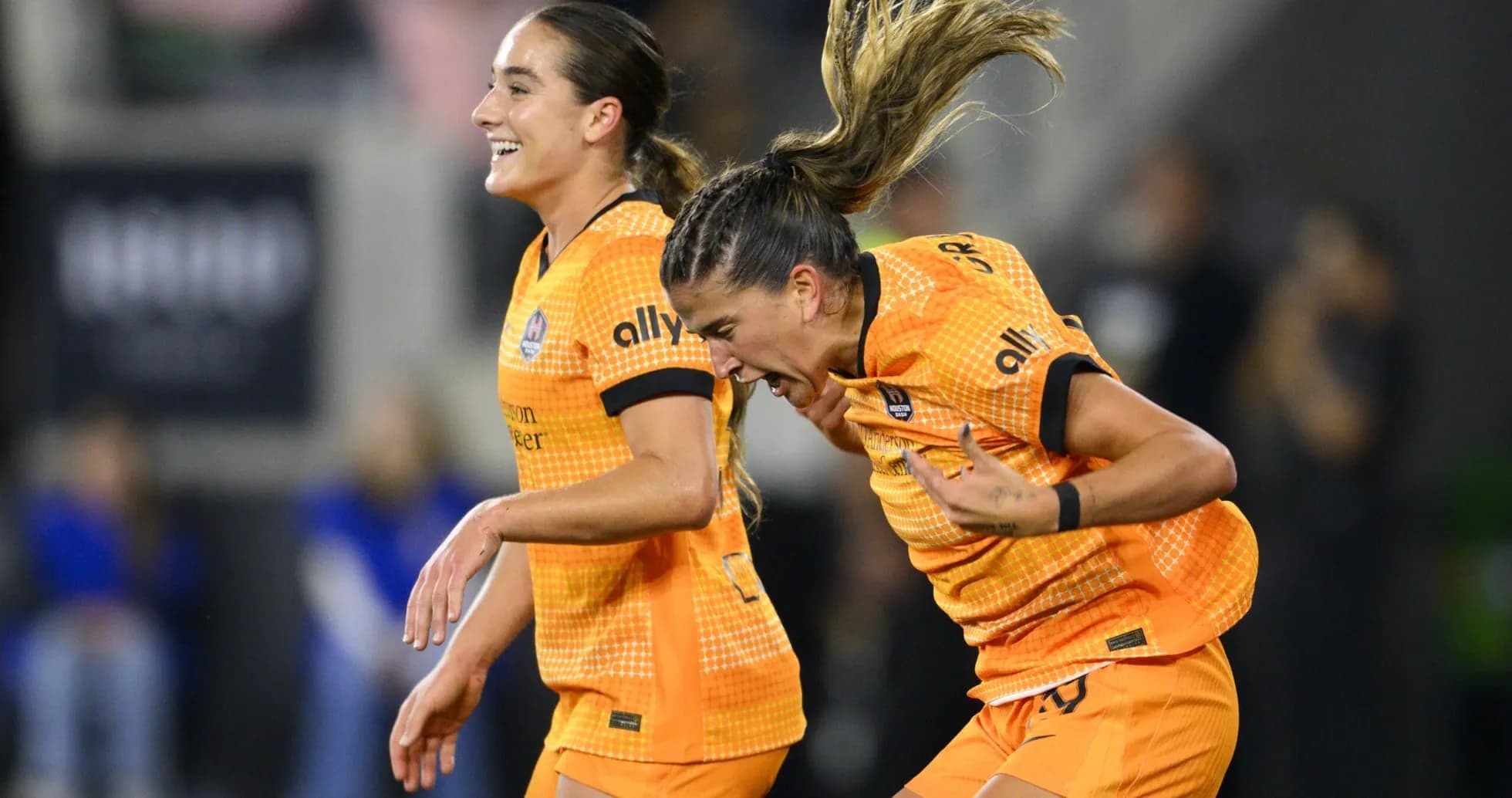 Two Houston Dash players celebrating a goal Two Houston Dash players celebrating a goal