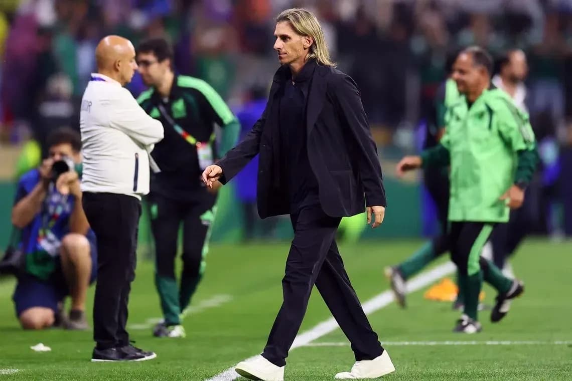 Coach walking on the pitch during match Coach walking on the pitch during match