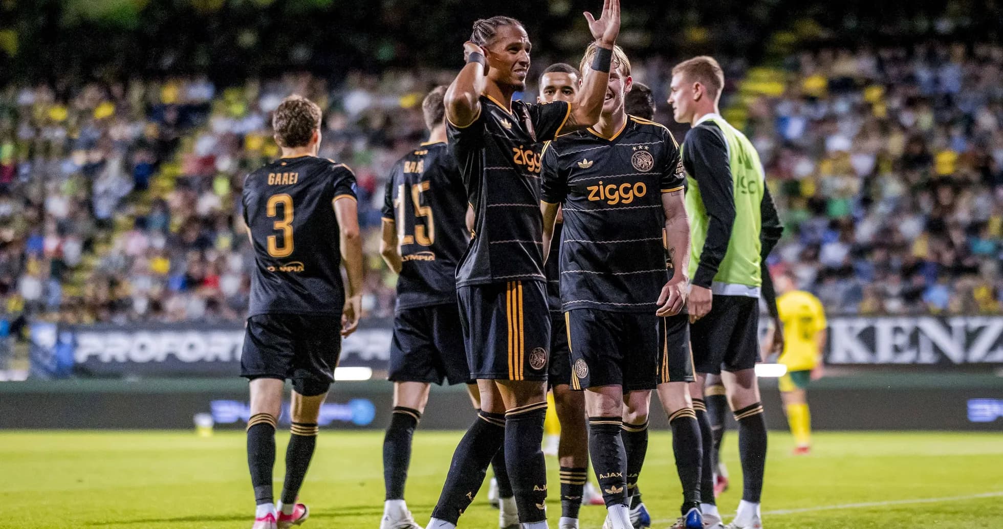 Ajax players celebrating a goal on the field Ajax players celebrating a goal on the field