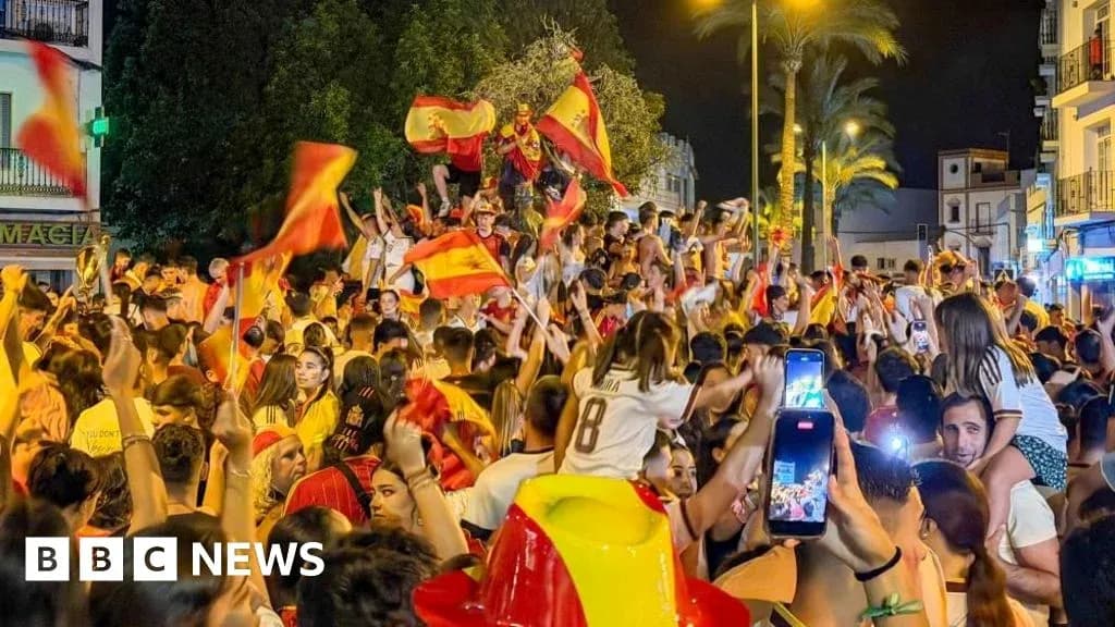 Crowd celebrating with flags in the street Crowd celebrating with flags in the street