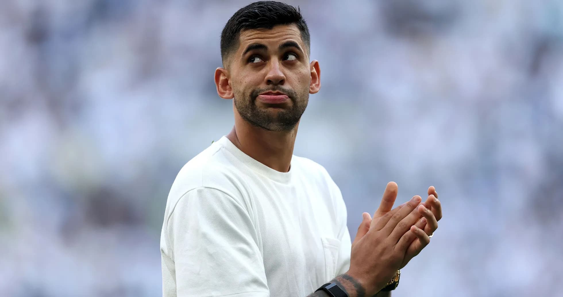 Player applauding during a stadium event Player applauding during a stadium event