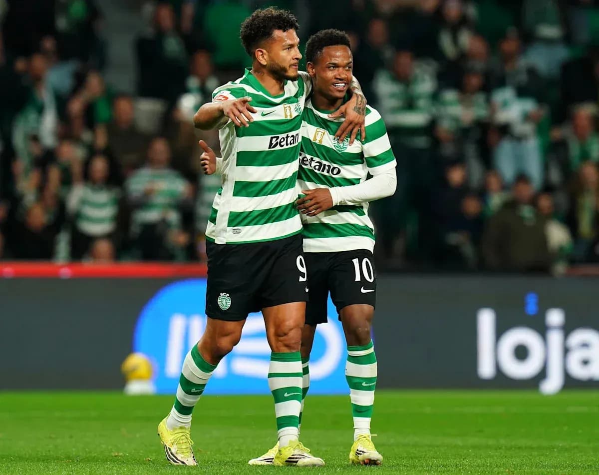 Two players celebrating on the field after a goal Two players celebrating on the field after a goal