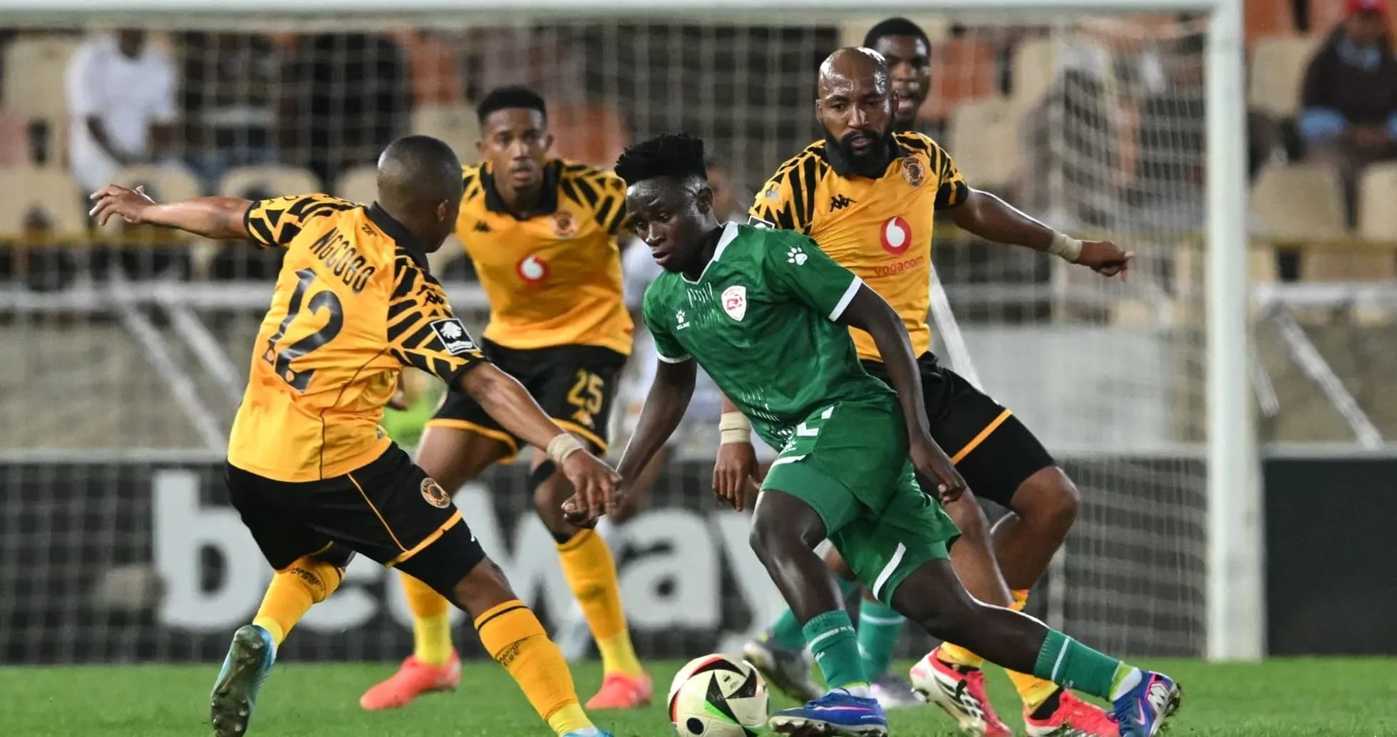 Players contesting for the ball during a football match Players contesting for the ball during a football match