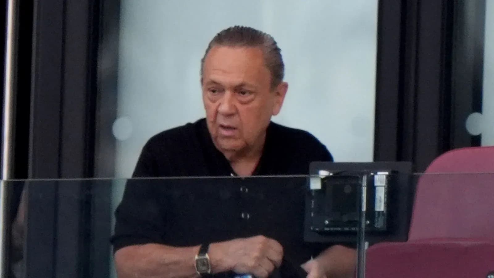 Man observing from a private box at stadium Man observing from a private box at stadium