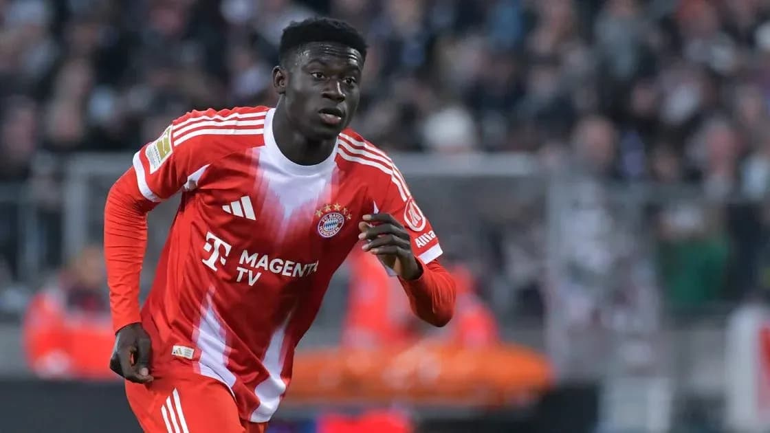 Player in Bayern Munich kit running on the field Player in Bayern Munich kit running on the field