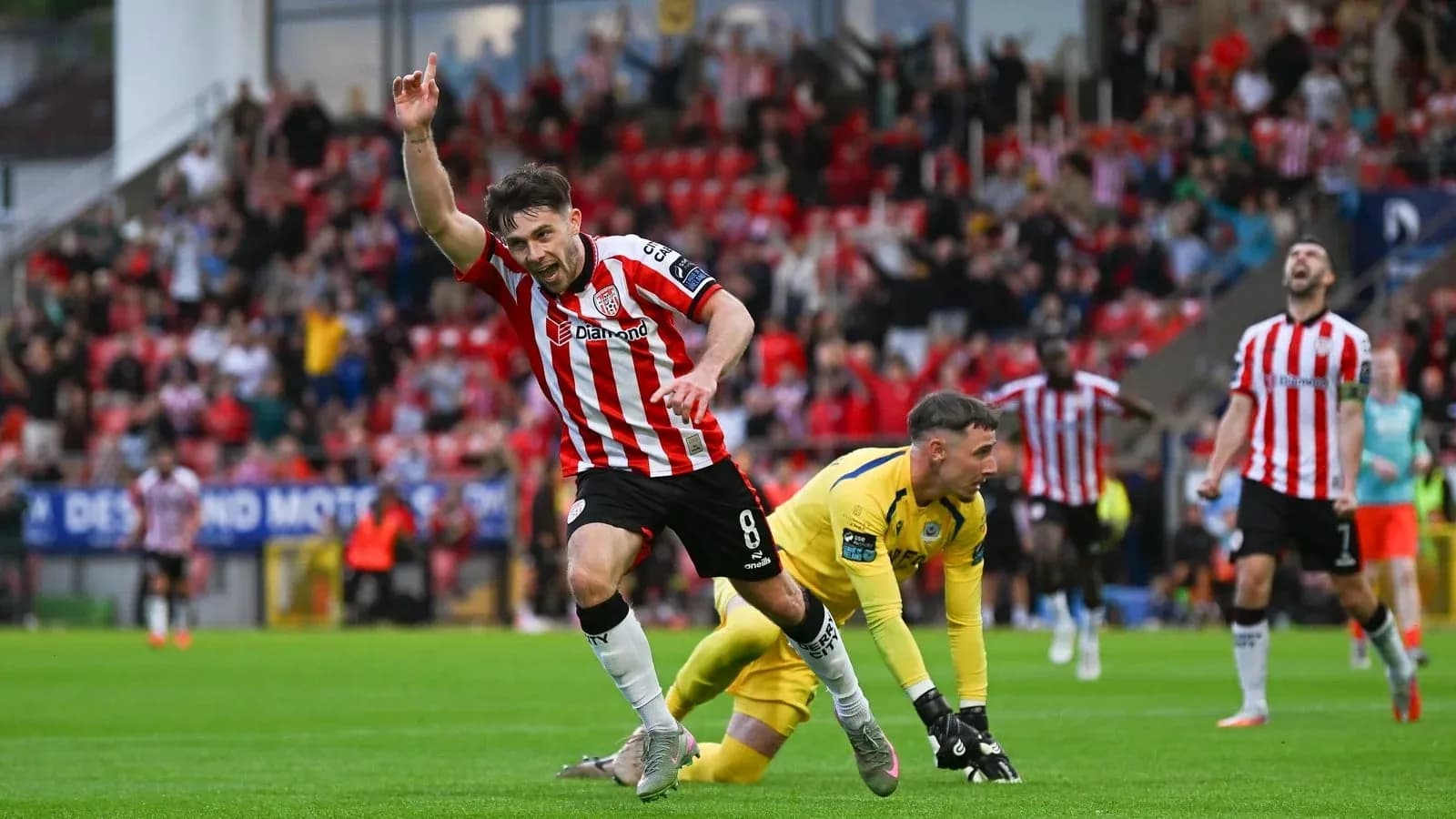 Player celebrating goal with fans in stadium Player celebrating goal with fans in stadium