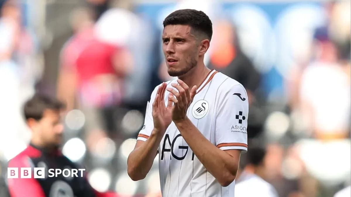 Swansea City player applauding fans after match Swansea City player applauding fans after match