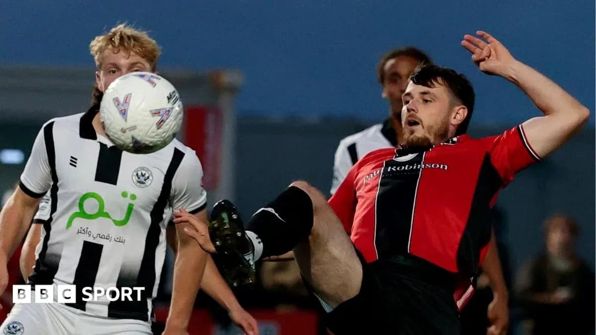 Player kicking the ball during a football match Player kicking the ball during a football match