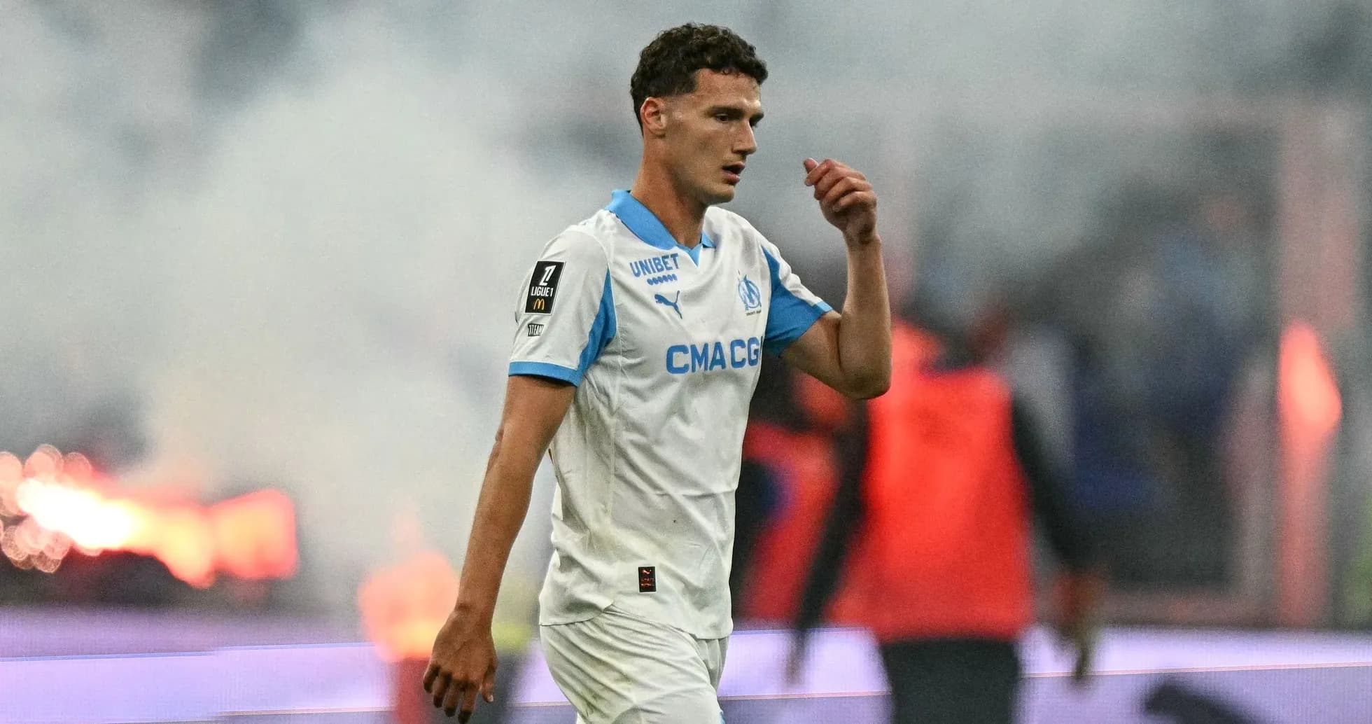 Player walking off the pitch during match with smoke Player walking off the pitch during match with smoke