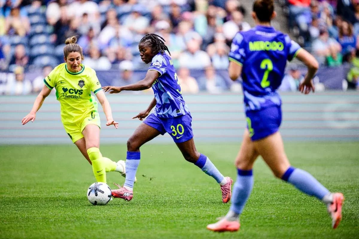 Players competing for the ball in NWSL match Players competing for the ball in NWSL match