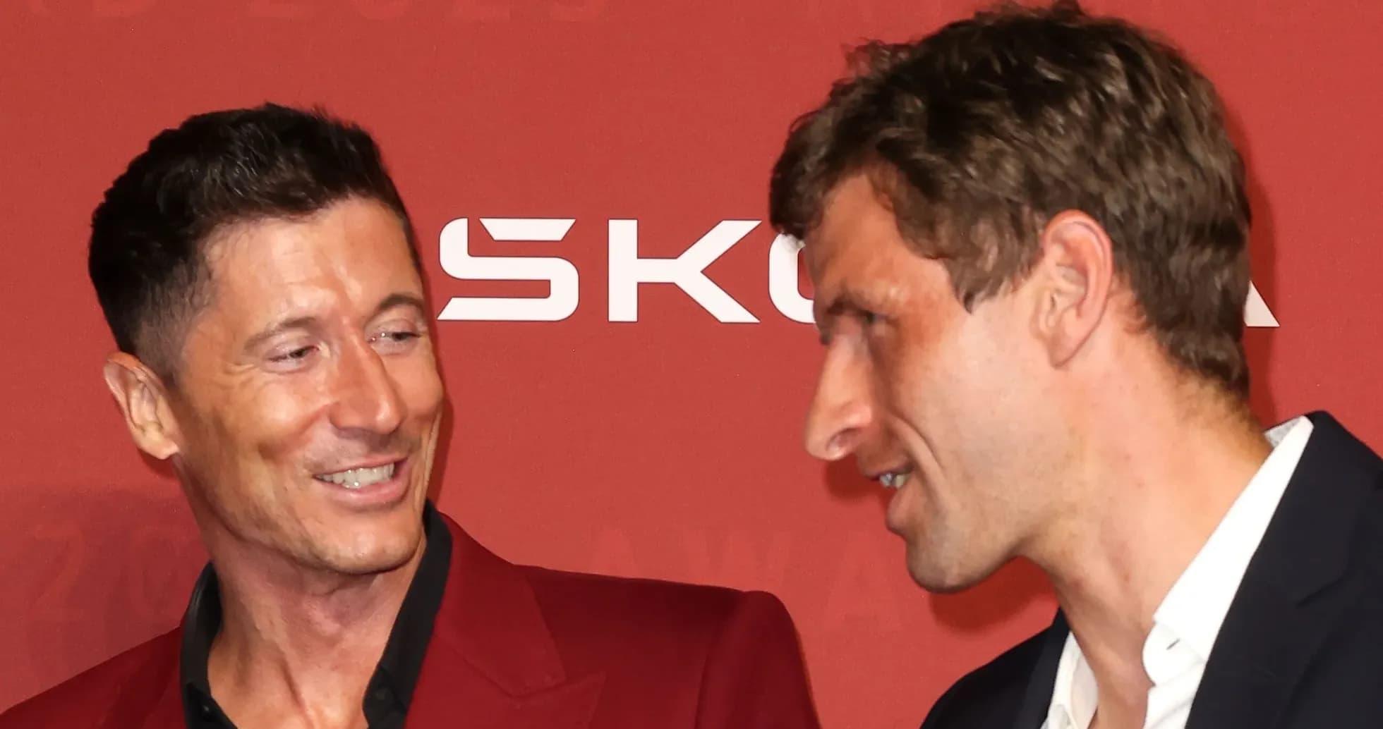 Two football players interacting at an award ceremony Two football players interacting at an award ceremony
