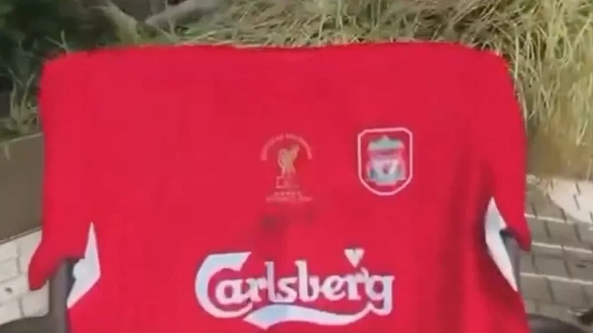 Red Liverpool jersey displayed on a surface Red Liverpool jersey displayed on a surface