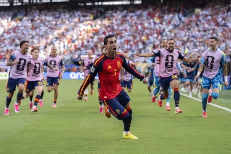 Spain player celebrating goal with teammates during match Spain player celebrating goal with teammates during match