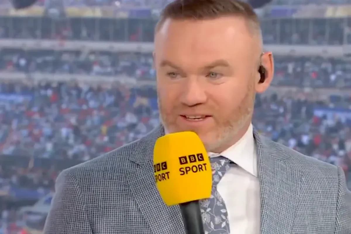 Sports commentator speaking into microphone on set Sports commentator speaking into microphone on set