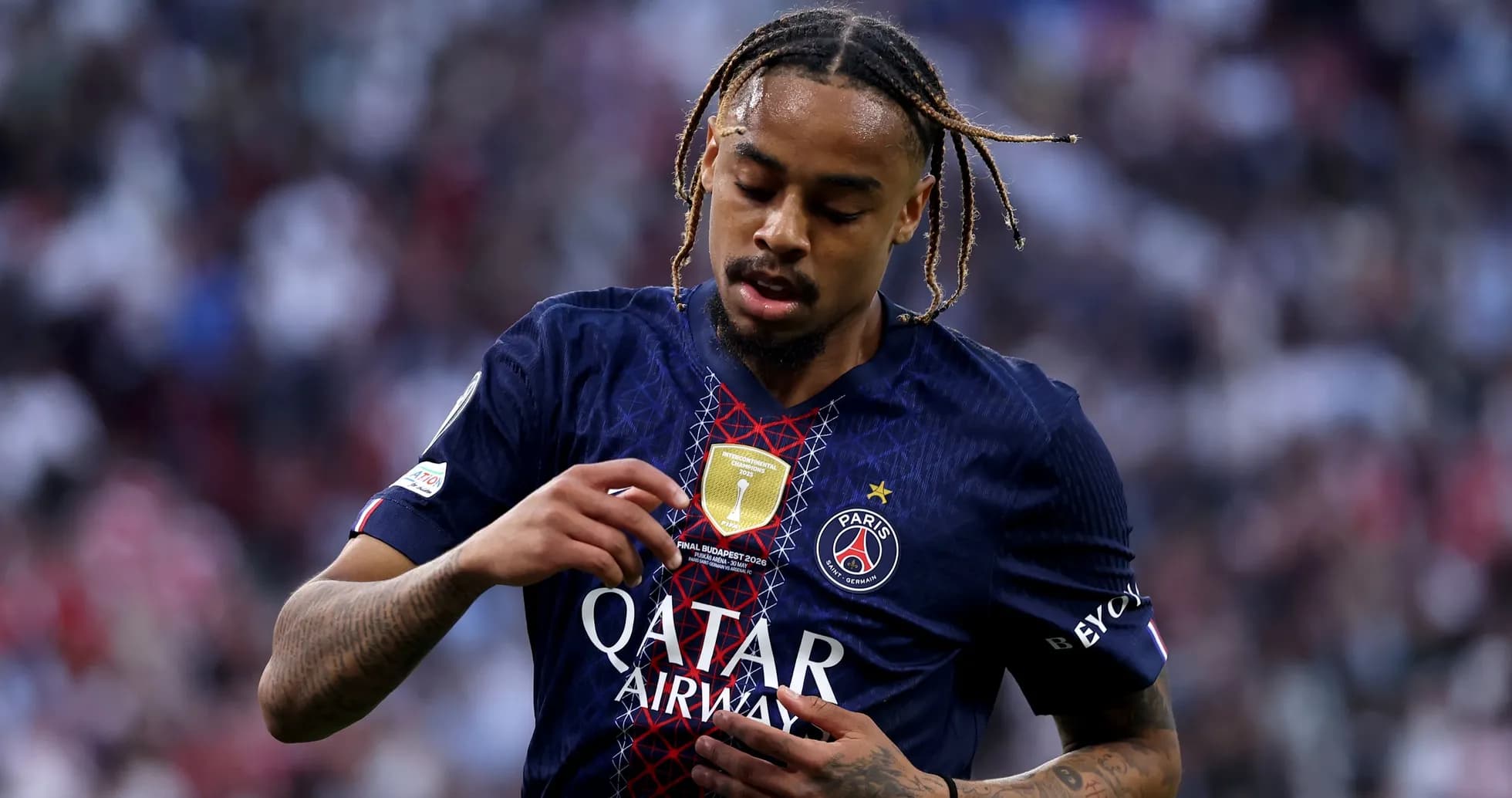 Player adjusting badge on PSG jersey during match Player adjusting badge on PSG jersey during match