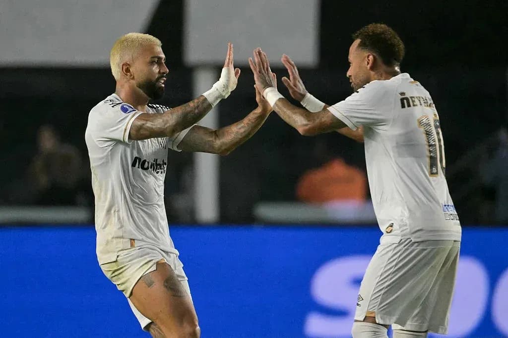Two players celebrating a goal on the field Two players celebrating a goal on the field