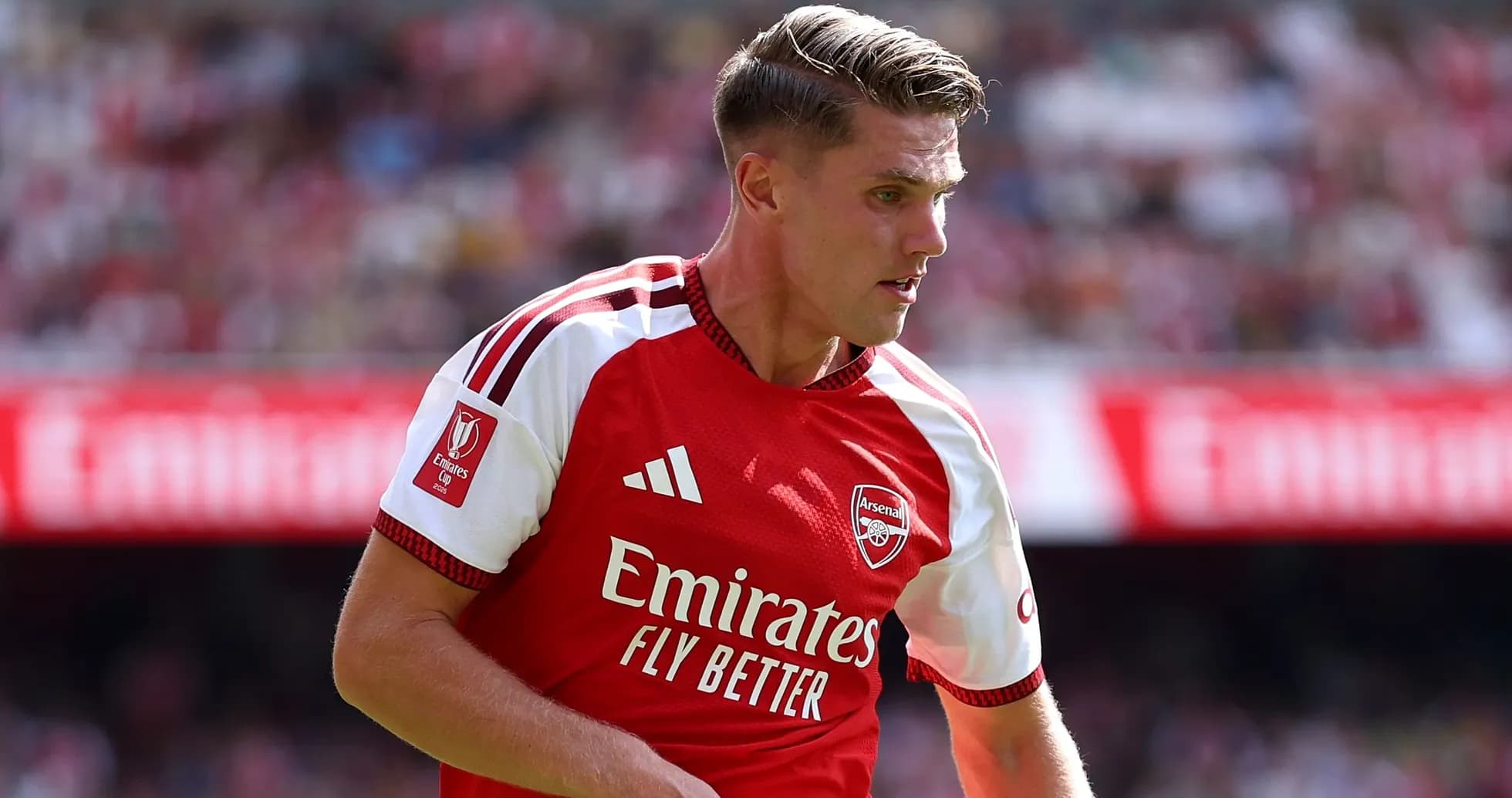 Player in Arsenal jersey during a match Player in Arsenal jersey during a match