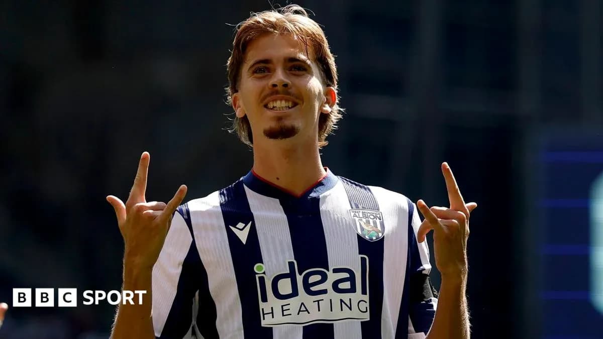 Player celebrating with hand gesture in team jersey Player celebrating with hand gesture in team jersey