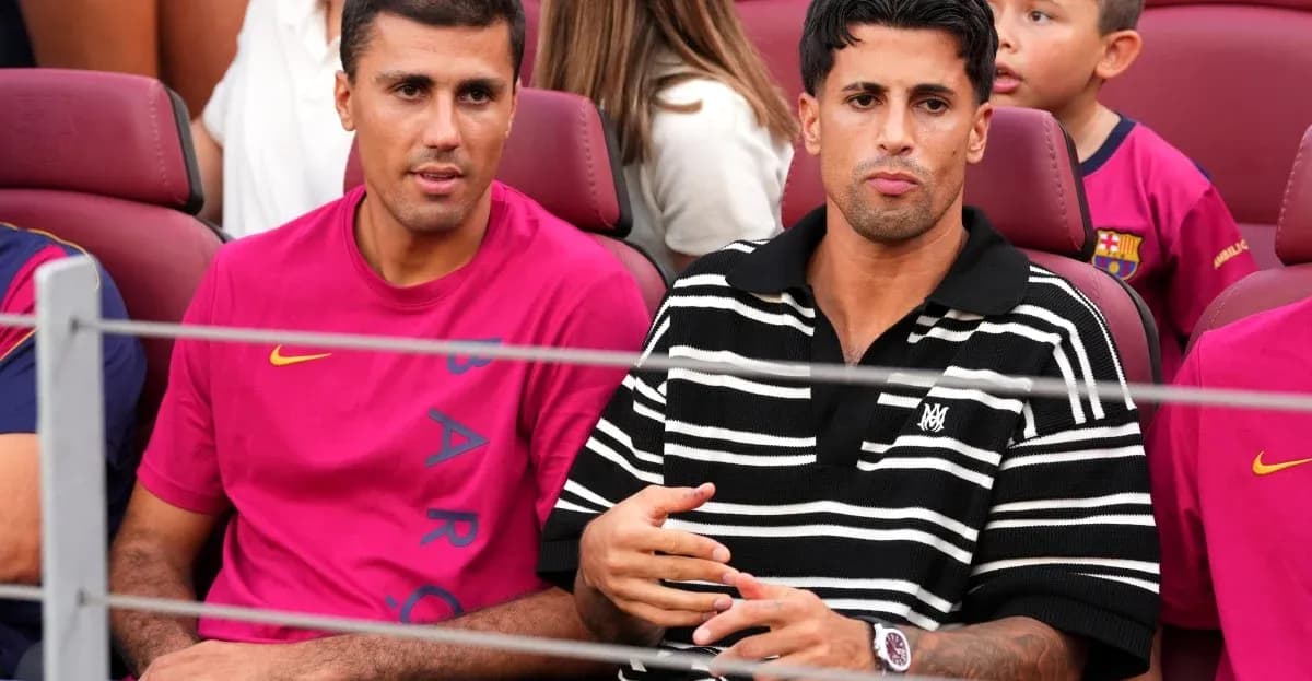 Two men seated in stadium wearing team jerseys Two men seated in stadium wearing team jerseys