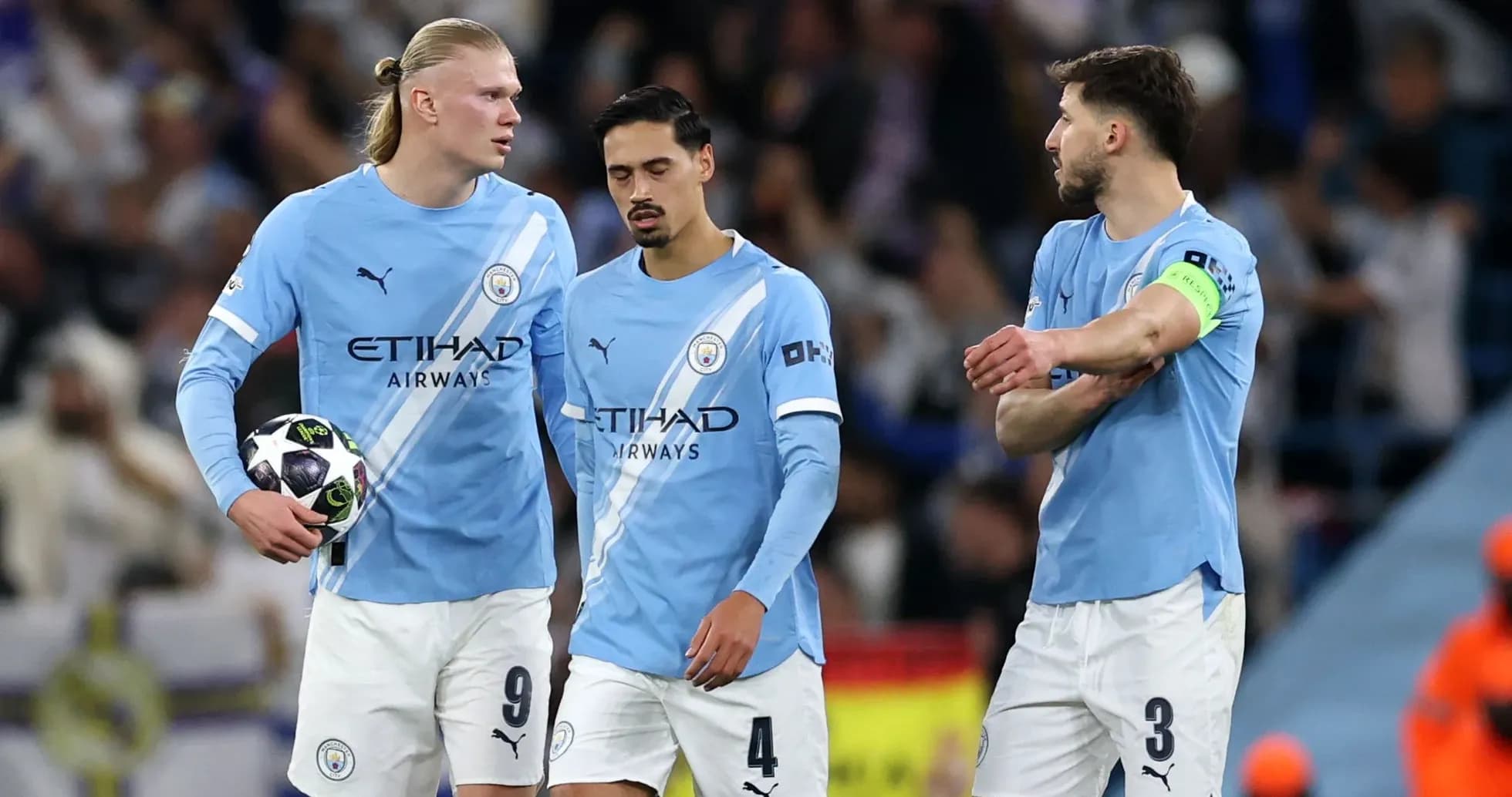 Three Manchester City players discussing on the pitch Three Manchester City players discussing on the pitch