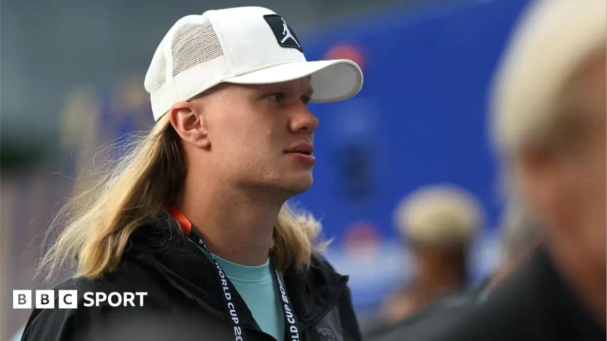 Person wearing a cap at an event venue Person wearing a cap at an event venue