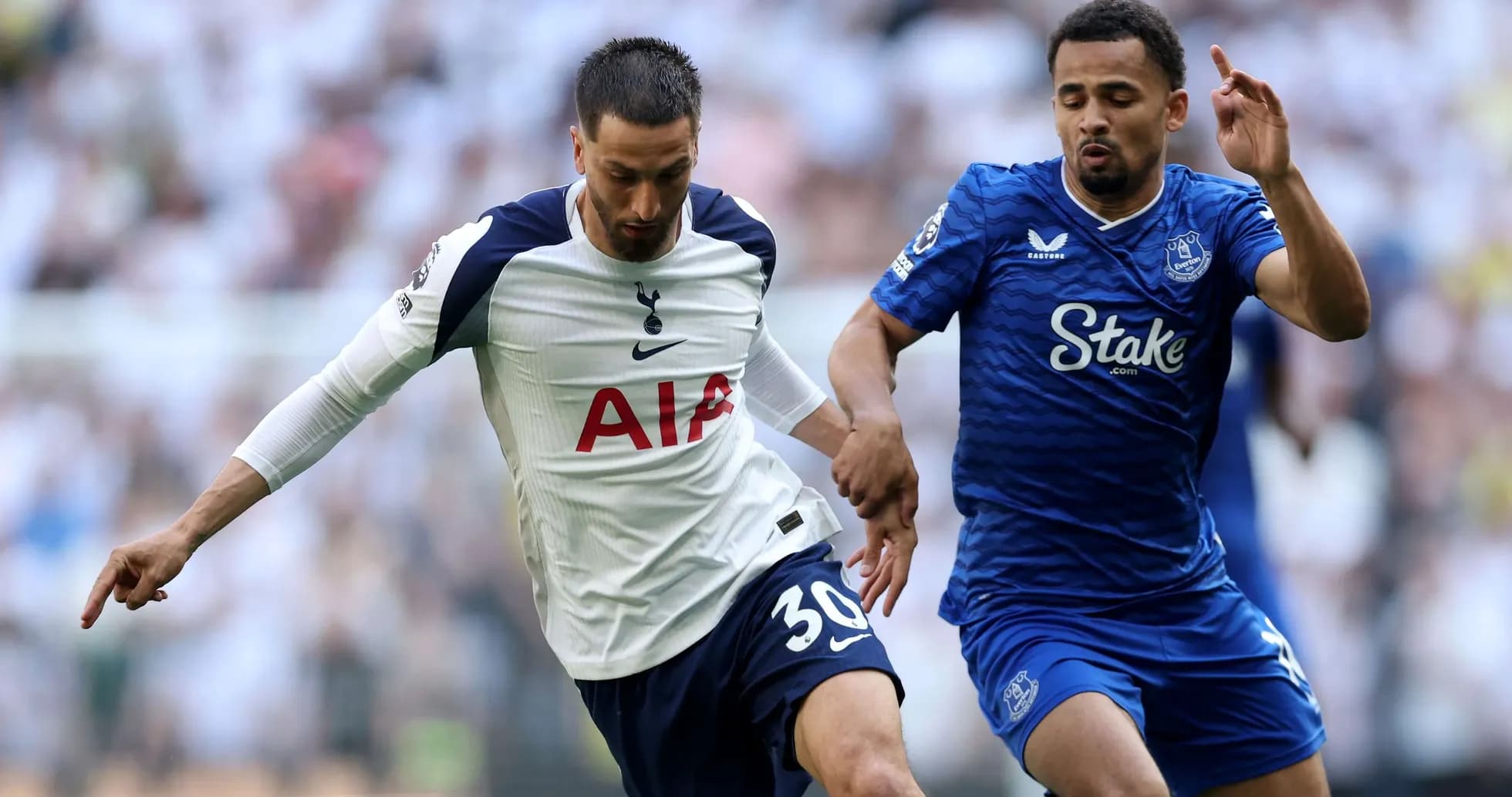 Tottenham player challenging Everton opponent for the ball Tottenham player challenging Everton opponent for the ball