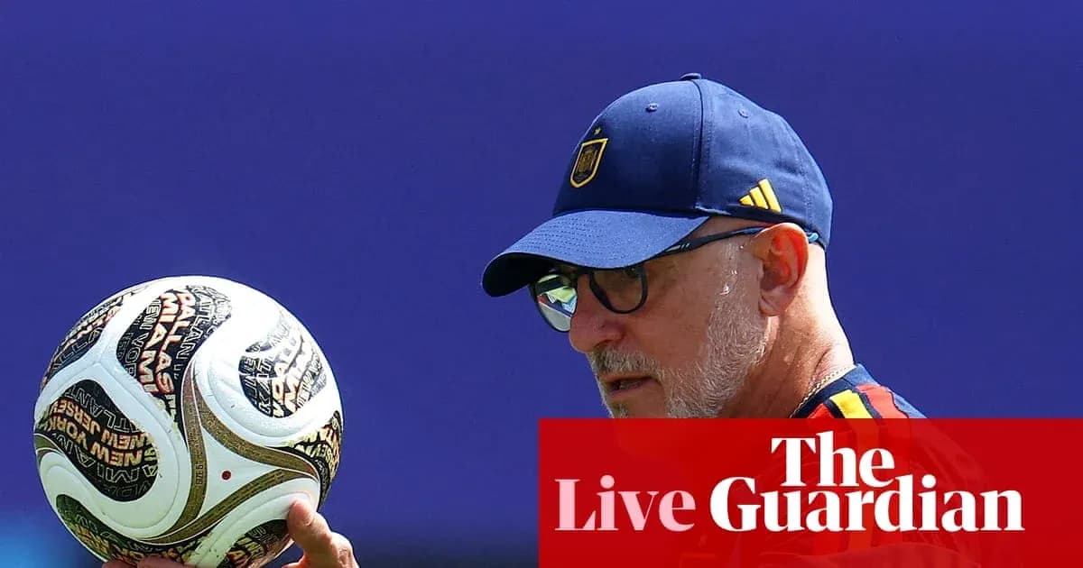 Coach holding a soccer ball during practice Coach holding a soccer ball during practice