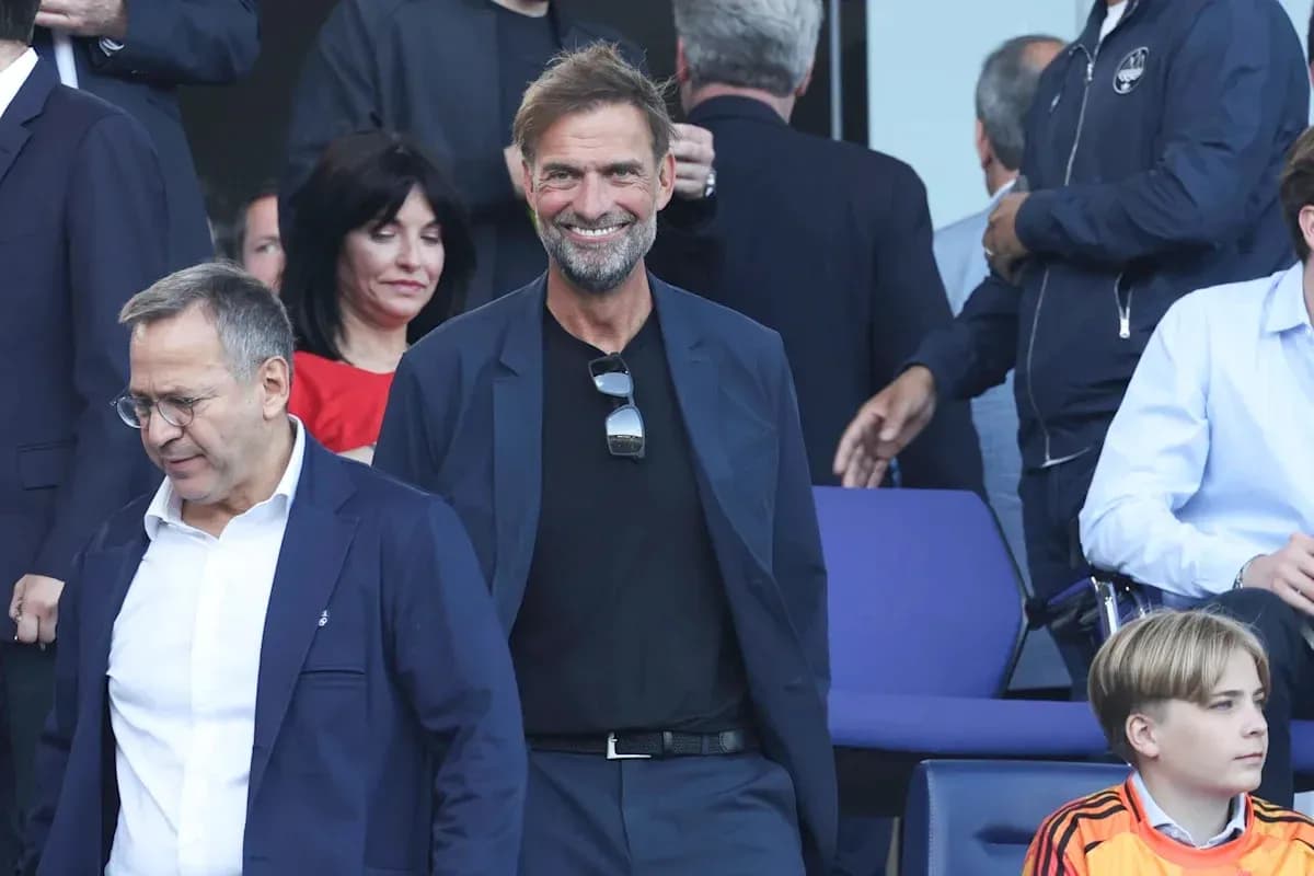 Jurgen Klopp smiling in a stadium setting Jurgen Klopp smiling in a stadium setting