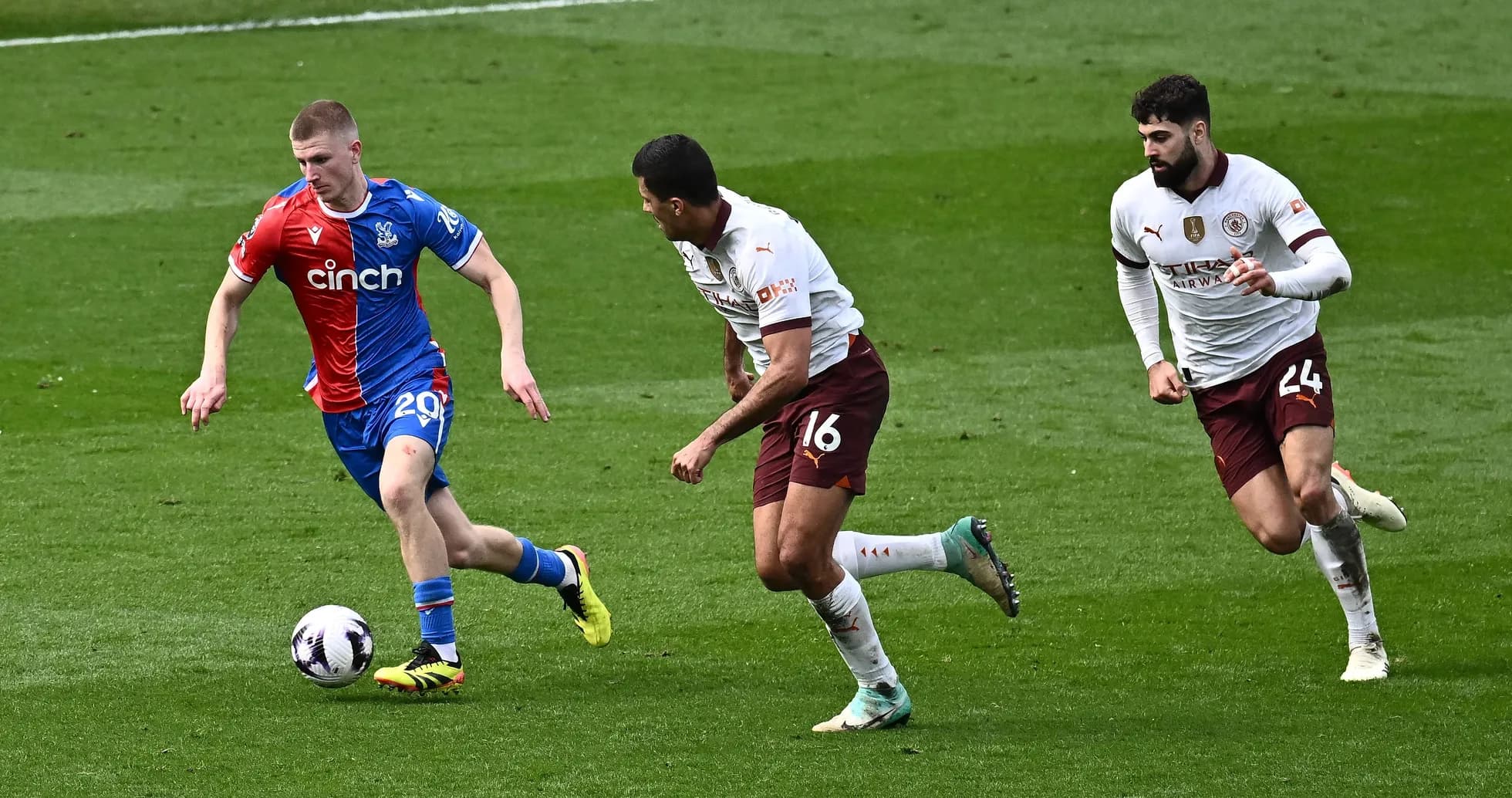 Player dribbling the ball, pursued by two defenders Player dribbling the ball, pursued by two defenders