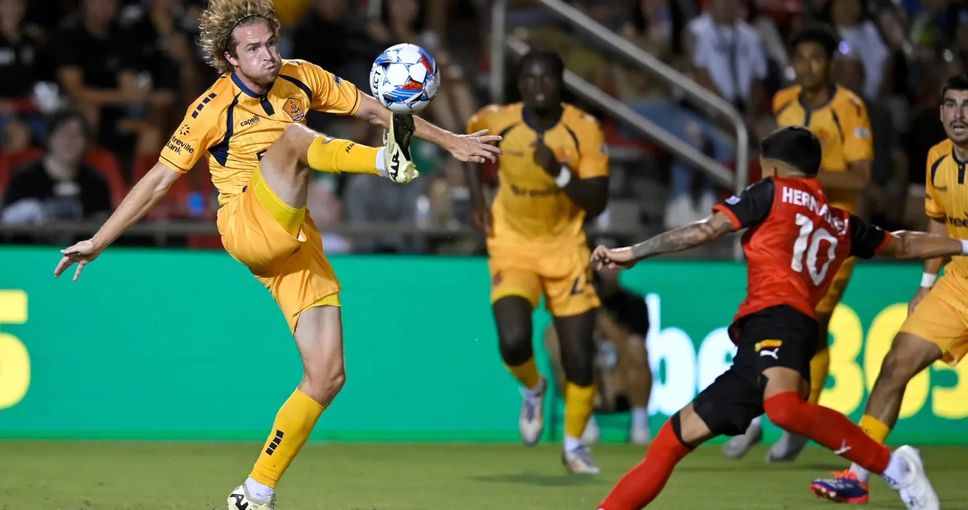 Player attempting to control the ball in match Player attempting to control the ball in match