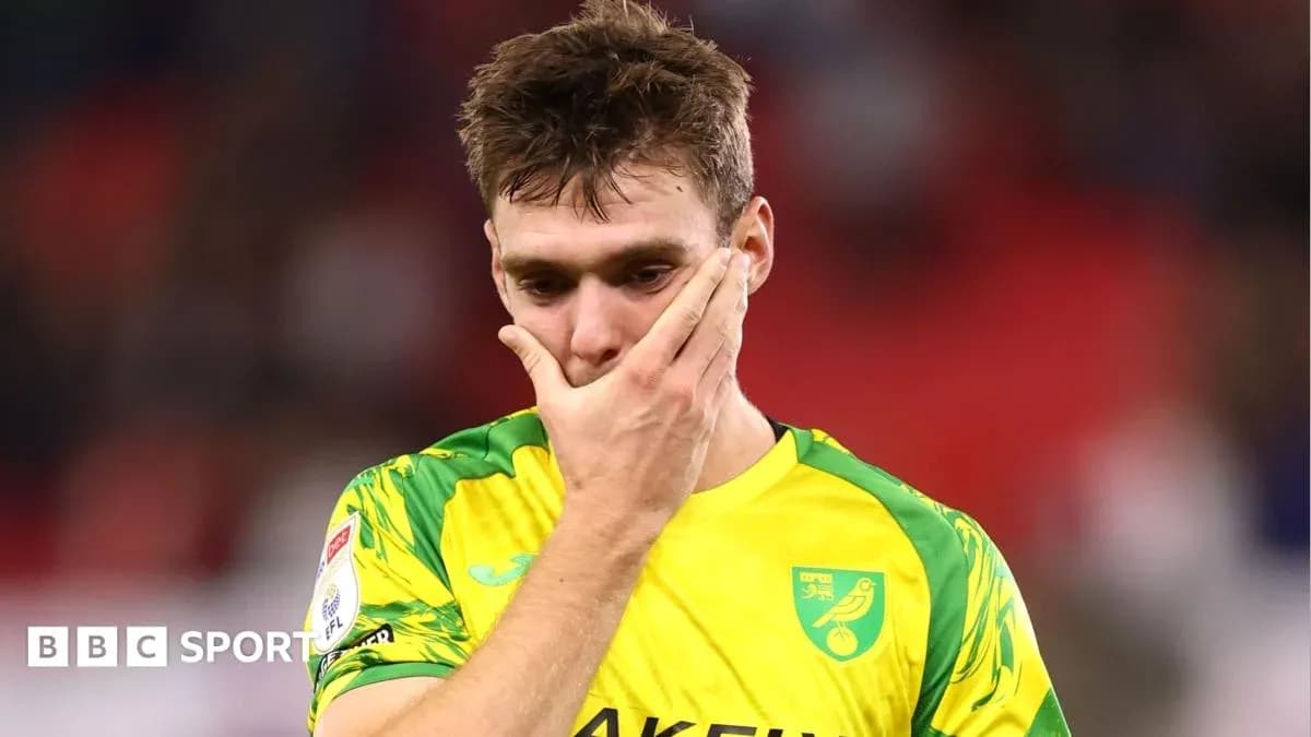 Player in Norwich City kit looking distressed Player in Norwich City kit looking distressed