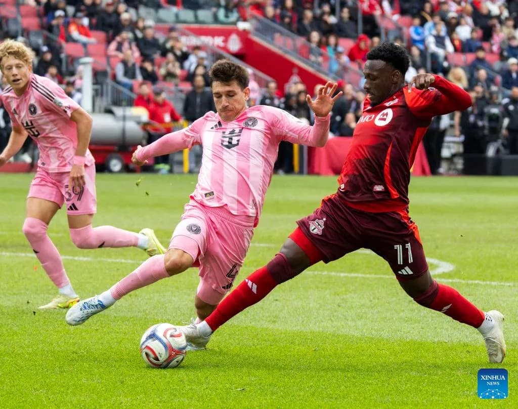 Players competing for the ball in MLS match Players competing for the ball in MLS match