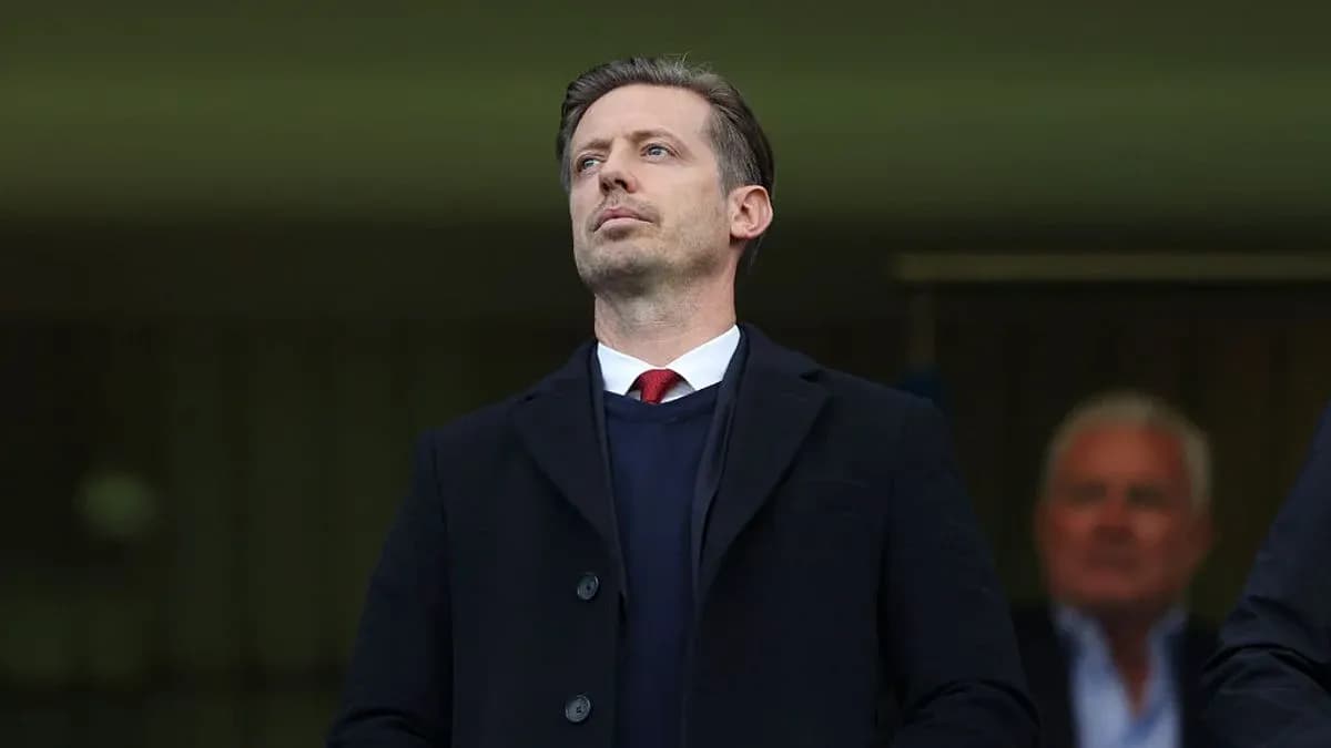 Man in suit observing from stands at stadium Man in suit observing from stands at stadium