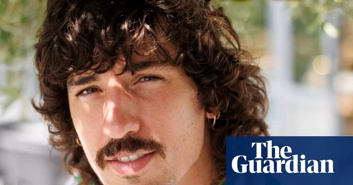 Man with curly hair and mustache smiling Man with curly hair and mustache smiling