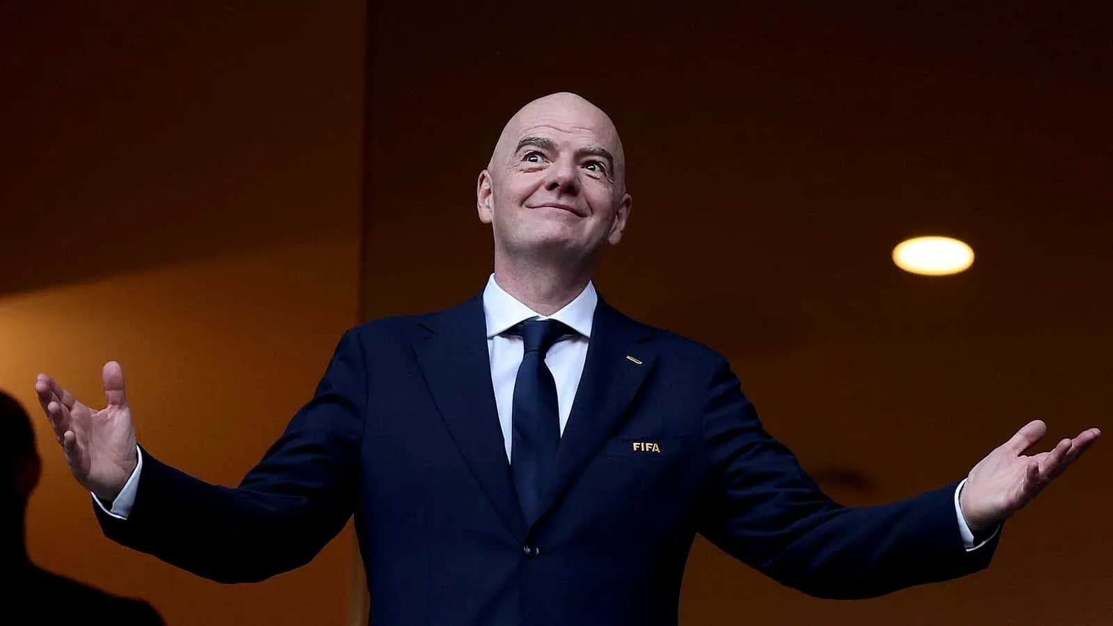 FIFA official speaking with arms raised FIFA official speaking with arms raised