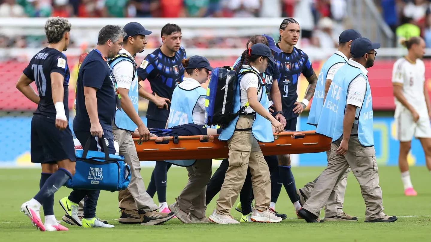 Medical team carrying injured player on stretcher Medical team carrying injured player on stretcher