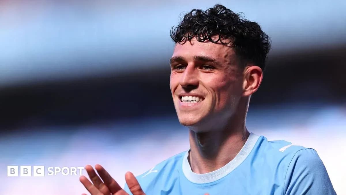 Player smiling and applauding on the pitch Player smiling and applauding on the pitch