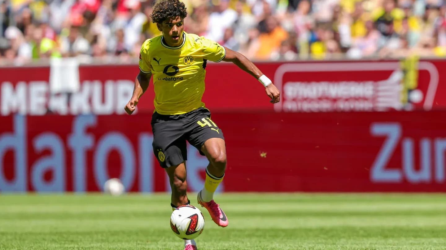 Player dribbling the ball during a match Player dribbling the ball during a match