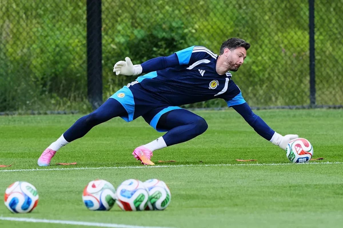 Goalkeeper diving to save a soccer ball during training Goalkeeper diving to save a soccer ball during training