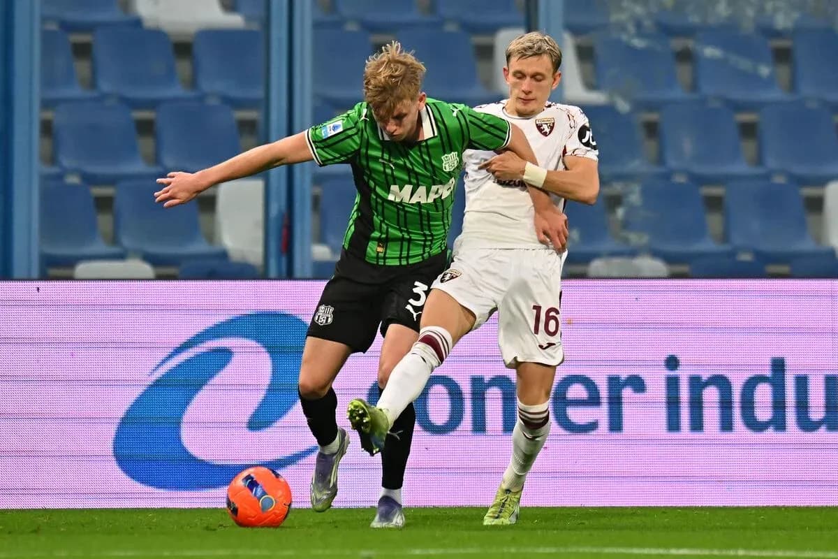 Sassuolo player challenging Torino opponent for the ball Sassuolo player challenging Torino opponent for the ball