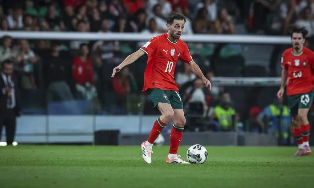 Player in red jersey dribbling the ball on field Player in red jersey dribbling the ball on field