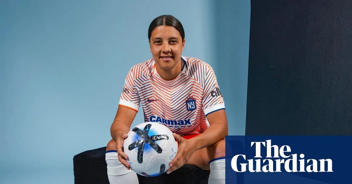 Player posing with soccer ball in team jersey Player posing with soccer ball in team jersey