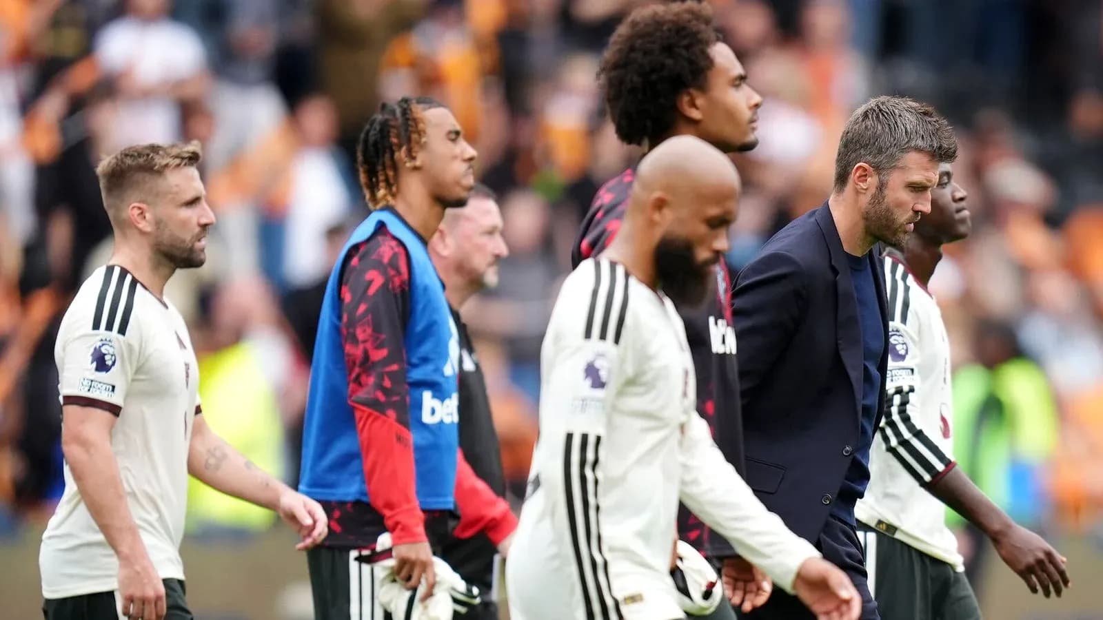 Players and coach leaving the pitch after match Players and coach leaving the pitch after match