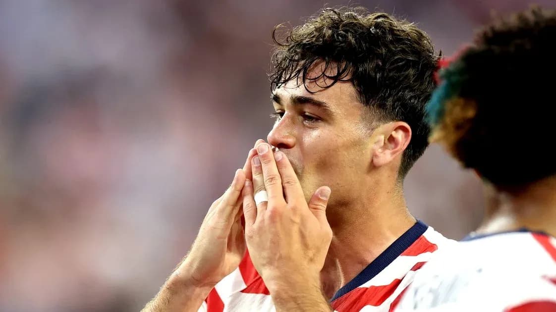Player celebrating with hands to mouth on field Player celebrating with hands to mouth on field