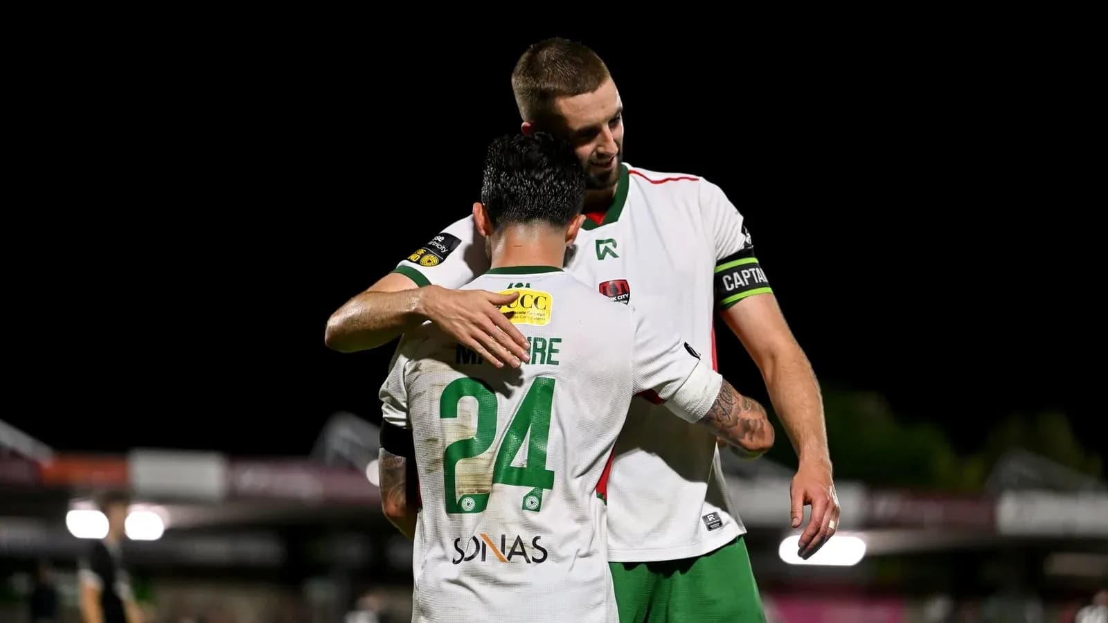 Players embracing on the field after match Players embracing on the field after match