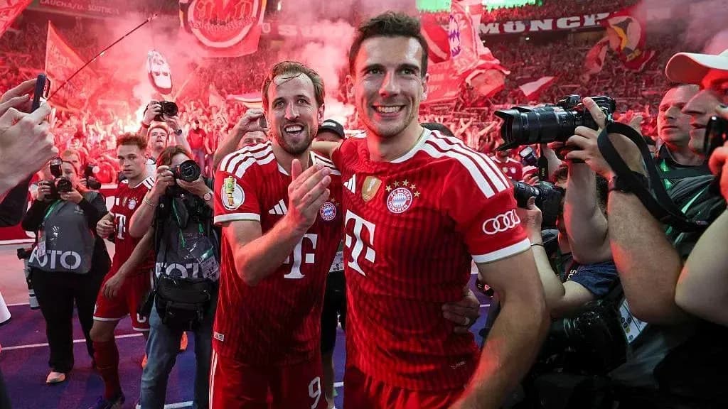 Bayern Munich players celebrating with fans after victory Bayern Munich players celebrating with fans after victory