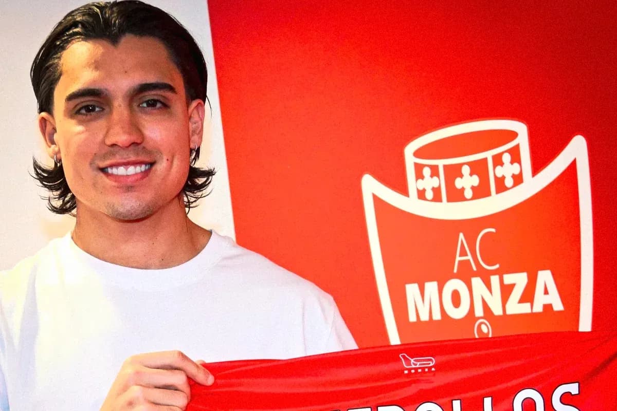 Player holding AC Monza jersey in front of logo Player holding AC Monza jersey in front of logo