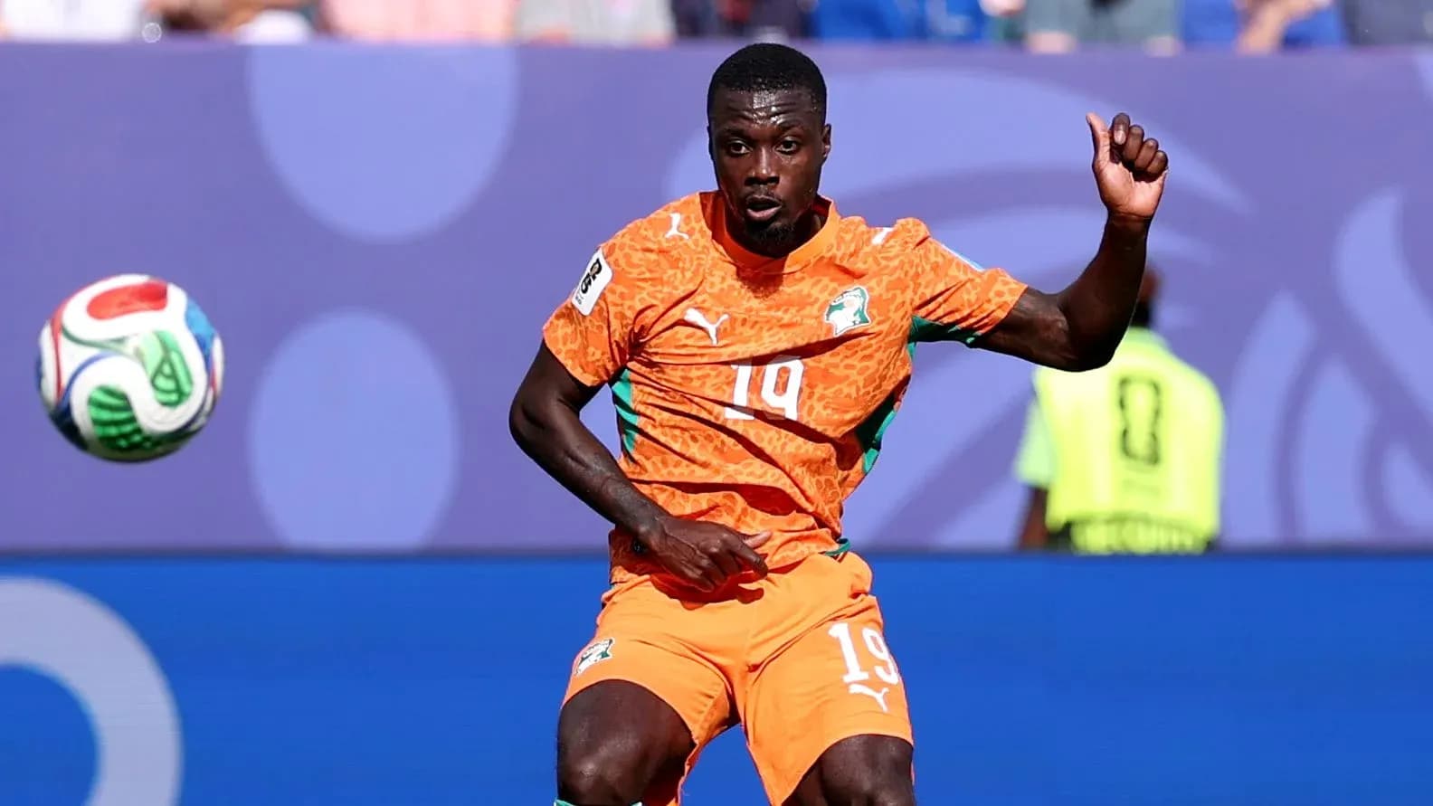 Player in orange kit controlling the ball during match Player in orange kit controlling the ball during match