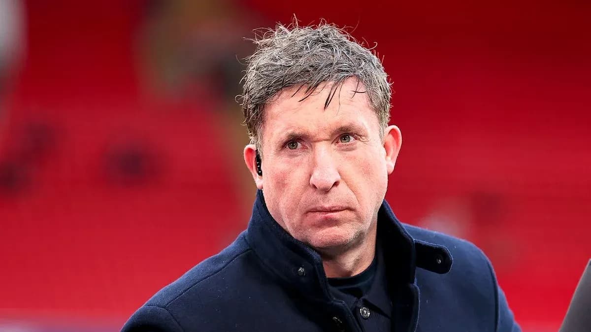 Man in a coat at a football stadium Man in a coat at a football stadium