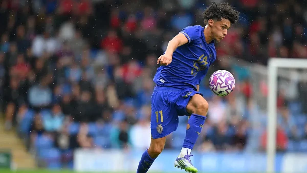 Player dribbling ball during match in rain Player dribbling ball during match in rain